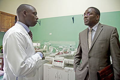A health worker speaks with Dr Luis Gomes Sambo (R) about service delivery at Nyamata District hospital. The New Times / Courtesy.