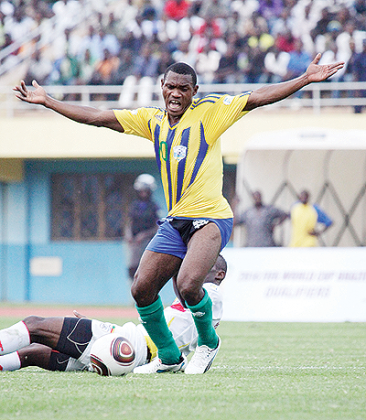 Bokota Labama being pulled back by Benin defender Jordan Adeoti during last weekendu2019s 2014 World Cup qualifier. The striker, despite his goal, is likely to start on the bench today. The New Times / T. Kisambira.