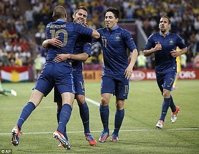 Delight: Jeremy Menez is mobbed after opening the scoring for France. Net photo.
