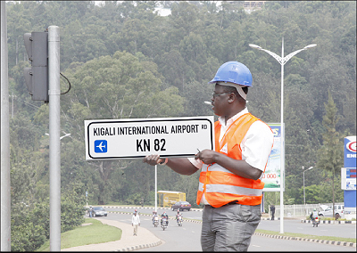 A technician installs new road signs in Kigali City in an exercise to rename all city roads and streets that started last week. The Sunday Times, / T. Kisambira
