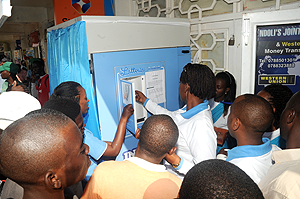 People getting milk from a public dispenser in Remera. The New Times / File.
