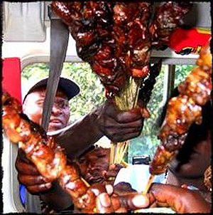 roadside vendors selling roasted meat to travellers.  Net photo.