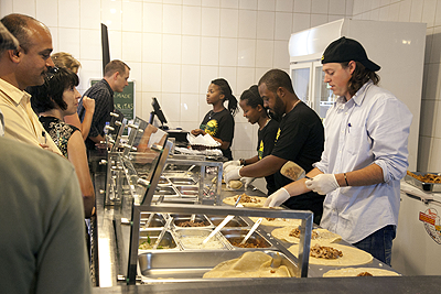 Customers help themselves to food. The Sunday Times / R . Spector