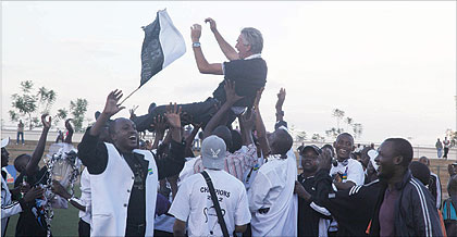 APR players lift their coach Ernie Brandts in the air after winning the national league. The army side is now one final win away from completing yet another double. The New Times  / File.