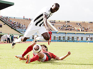 Olivier Karekezi, seen here jumping out of a challenge by Etoile du Sahel defender,  has been cleared to play in tomorrowu2019s MTN Peace Cup final. The New Times/T. Kisambira.