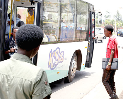 A passenger about to board a KBS bus. The New Times / Timothy Kisambira.
