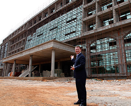 Marriott International vice president of Sales and Marketing, Jeff Strachan, inspects the structure.  The New Times / T.Kisambira.