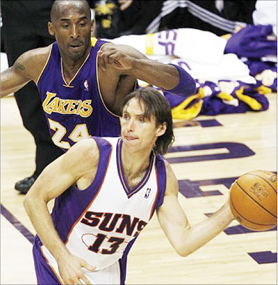 In this file photo, Phoenix Suns guard Steve Nash passes the ball with defender Los Angeles Lakers guard Kobe Bryant. Net photo.