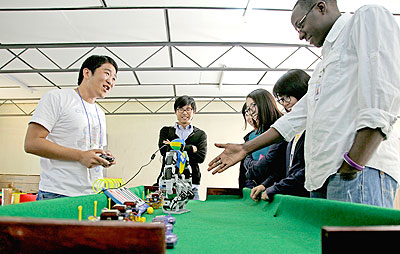 An exhibitor demonstrates how a robot works during the ICT Expo at IPRC-Kigali. The New Times / Timothy Kisambira.