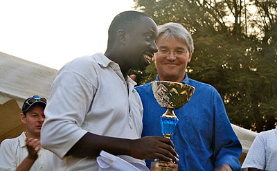 UKu2019s International Development Secretary Andrew Mitchell (R) presenting the trophy to the captain of RCAu2019s select side captain Dennis Mukama. The New Times/Courtesy.