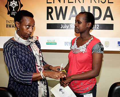 Dr Marie-Christine Gasingirwa, (L)the Director General of Science and Technology at the Ministry of Education chatting with Jessie Gakwandi the winner of African Innovation Award. The New Times / Timothy Kisambira.