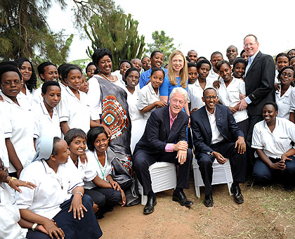 President Kagame and Bill Clinton, pose for a photo with Co-founder Partners in Health Dr Paul Farmer, Minister Dr Binagwaho, Clintonu2019s daughter Chelsea, and nursing students at the Rwamagana School of Nursing and Midwifery, yesterday. The New Times / Vil