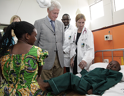 President Clinton visits one of the cancer patients at the Butaro Hospital where he inaugurated a cancer centre of excellence on Wednesday..