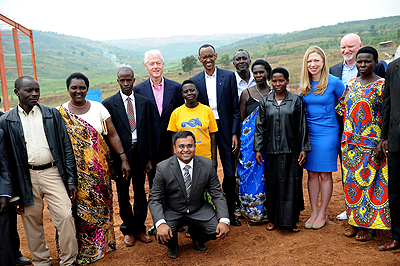 Presidents Kagame and Clinton, Chelsea Clinton, Vice Chairman of Mt. Meru Soyco factory Arvind Patel and soy farmers in Kayonza District on Thursday.