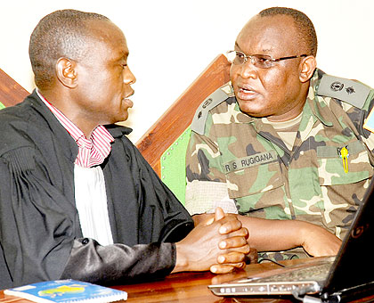 Lt. Col. Rugigana Ngabo (R) with his lawyer Geofrey Gatare in court yesterday. The New Times / John Mbanda.