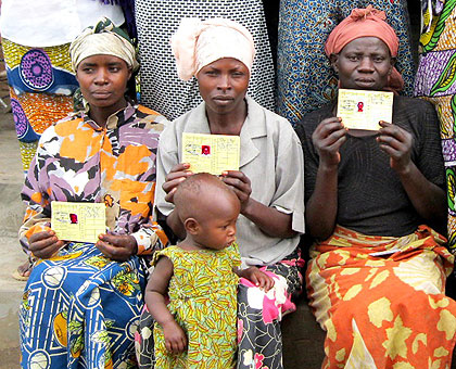Proud to have their Mutuelle de Santu00e9 cards. Other EAC citizens are asking for the opportunity. The New Times / File.