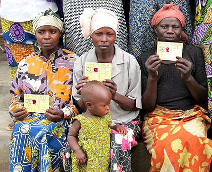 Proud to have their Mutuelle de Santu00e9 cards. Other EAC citizens are asking for the opportunity. The New Times / File.