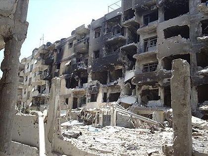 Damaged buildings are seen at Al Qussoor area in Homs city July 25, 2012.  Net photo.