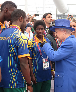 Claudette Mukasakindi (Centre), and Chef de Mission Serge Mwambali (L) share a light moment with Queen Elizabeth II in the Olympic Village on Saturday.