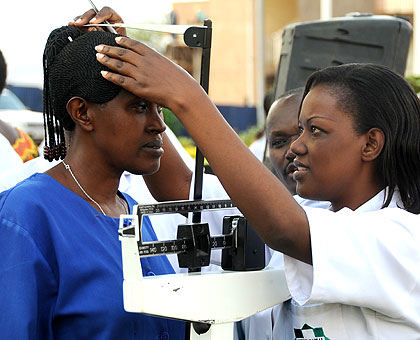 A nurse at King Faisal Hospital takes a patient's measurements. It is the only health facility which has a running haemodialysis unit. The New Times / File.