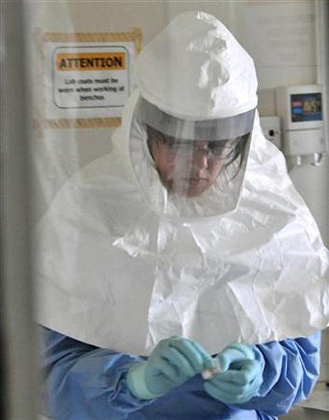 A laboratory specialist examines specimens of the Ebola virus at the Uganda virus research centre in Entebbe. Net photo.