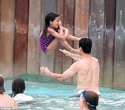 Up, up and away. Tom catapulted brave Suri into the waves as they splashed about in the water. Net photo