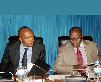Premier Pierre Damien Habumuremyi (R) consults with the Ministry of Agriculture PS, Ernest Ruzindaza, before presenting the Status of Agriculture report before Parliament on Thursday. The New Times / John Mbanda.