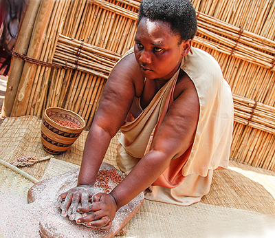 During the National Harvest Day Celebration,  a Rwandan woman showcased how millet flour was processed in the earlier days.  The Sunday Times /Robyn Spector.