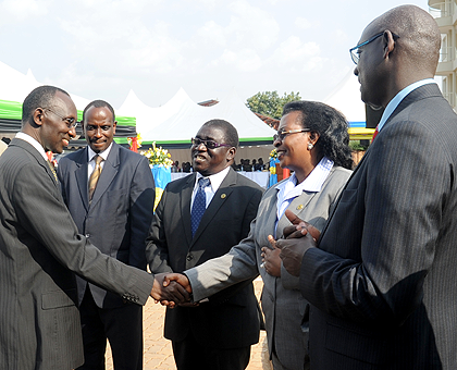 Chief Justice Sam Rugege (L) greets EALA Speaker Margaret Zziwa while looking on are EAC Secretary General Dr. Richard Sezibera (2 left) , East African Court of Justice President Harold Nsekela (2 right)   and Principal Judge Johnston Busingye at the inau
