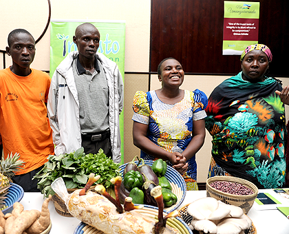 Honoree Nyirahagumimana (2nd right) together with other beneficiaries of imbuto Foundation displaying some of their agricultural produce at the Imbuto's 10th anniversary event. The Sunday Times /Courtesy.