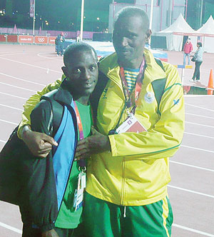 Robert Kajuga and his coach Innocent Rwabuhihi after competing in the 10,000m at the London Games. The New Times/Courtesy.