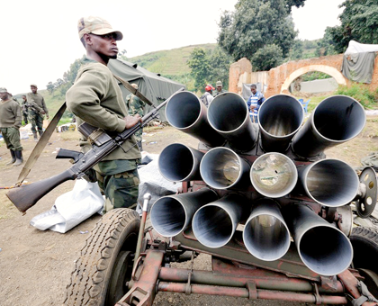 M23 fighters show off a captured rocket launcher found on a hill overlooking the border town of Bunagana. The rebels captured the hill and the town from government forces on July 6. Net photo.