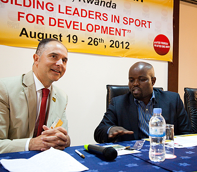 Robert Wicthel (L)National Director Canadian Nation Office Right to Play with Youth and ICT minister Jean Philbert Nsengimana yesterday at the meeting. The New Times / Timothy Kisambira.