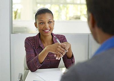 Use hand gestures and smile moderately during a job interview. Net photo.