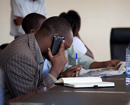 A man talks on a mobile phone. The New Times / File.