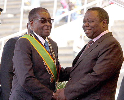 President Robert Mugabe shaking hands with Prime Minister  Morgan Tsvangirai.  Net photo
