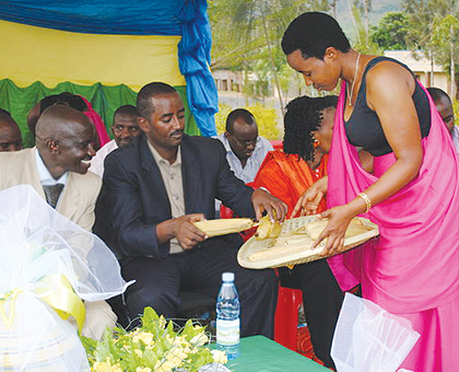 The Mayor of Gatsibo District, Ambrose Ruboneza, being served with maize during the function that raised over Rwf 10 million for the Agaciro fund. The New Times / Courtesy.