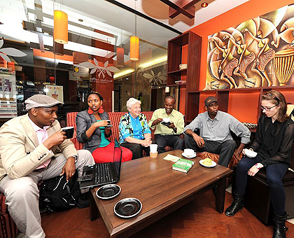 Sister Ann Fox (third from left) and Jean Nganji (fourth from left) are joined by friends at Cambridgeu2019s Bourbon Coffee. Photo/Boston Metro. 