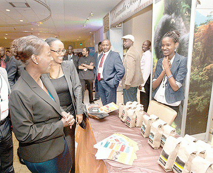 Foreign Affairs Minister, Louise Mushikiwabo and Vivian Kaitesi of RDB visit a Coffee stand during Rwanda Day event in Boston, Massachusetts. The Sunday Times / Courtesy.