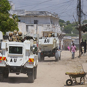 African Union troops sail through a war ravaged suburb of the Somali capital Mogadishu. Net photo.