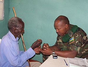 An RDF doctor attends to an elderly patient at Gihundwe hospital recently during a free treatment campaign. The New Times / File.