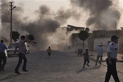 Smoke rises over the streets after mortar bomb landed from Syria in the border village of Akcakaler on October 3 Net photo.