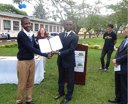 Minister Harebamungu awards one of the students who participated in the competition. The New Times / JD Mbonyinshuti.