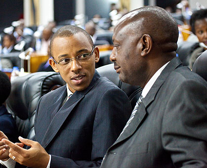 MPs Thiery Karemera (L) and Abbas Mukama chat during the consultative meeting at Parlaiment yesterday. The New Times Timothy Kisambira