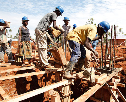Builders at a construction site. The New Times / Timothy Kisambira.
