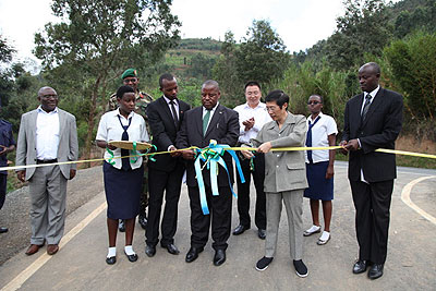 Chinese Ambassador SHU Zhan and Provincial Governor Bosenibamwe cut a tape during the commissioning of the road. The New Times / Courtesy.