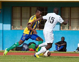 Patrick Sibomana who is seen here trying to dribble past Botswana's Simone Botlme scored the lone goal for Rwanda despite losing qualification on penalties. The Sunday Times / T. Kisambira.