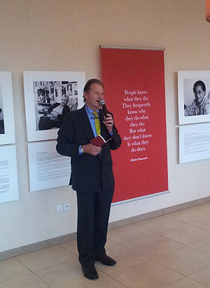 A guest speaks at the launch of the photo exhibition. The New Times / Courtesy.