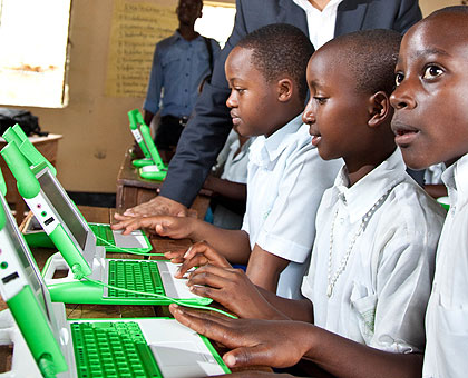 Pupils busy on their green-and-white laptops. The New Times / File.