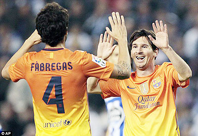 Lionel Messi (right) celebrates with Cesc Fabregas in Barcelonau2019s latest triumph. Net photo.